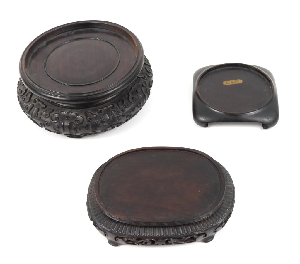 3 Antique Asian Wood Carved Stands: A 3-3/4" square stand with a 3" diameter rest.An oval nicely carved stand that measures 5-1/8" x 3-3/4" x 1-1/4" high. Rest measures 2-3/8" x 4-1/8".A 6" diameter double waisted stand that is 2-1/4"
