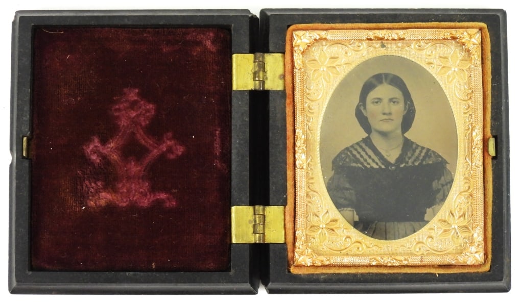 Antique Photographic Portrait in a case of a Woman: A beautiful, clear 9th plate tintype portrait of a woman with hand-tinted pink cheeks, in a dress wearing a necklace. Photograph is under protective glass and has brass mat and frame, and is mounted