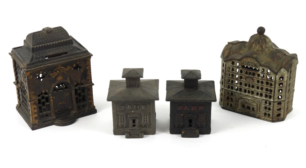 Grouping Of Antique Cast Iron Banks: A savings bank with gold highlights made by J & E Stevens. Has a replaced center screw with nut. Measures 5" high. A Domed bank painted silver and gold made by the A.C. Williams Co. that measures 5" h