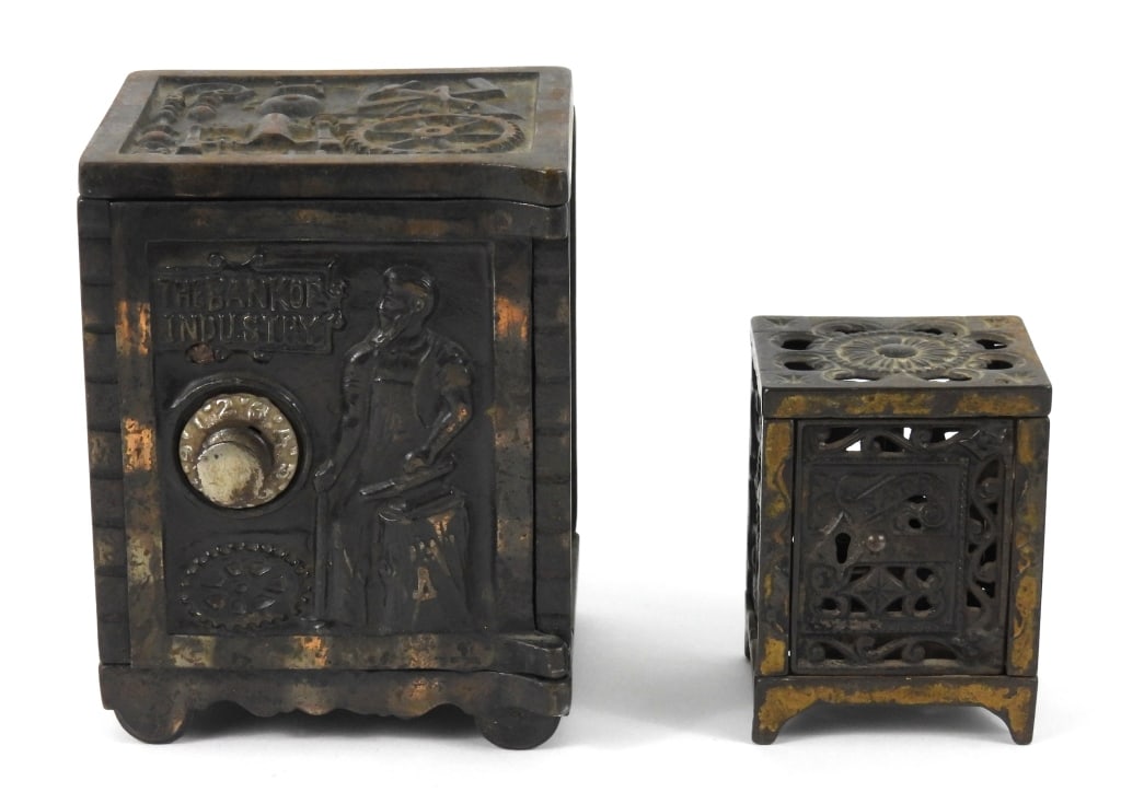 Two Cast Iron Safe Banks: A Kenton Brand Bank of Industry combination lock bank that measures 4" x 3-3/4" x 5" high. A small ornate locked door bank that measures 2-1/8" x 2-1/2" x 3-1/4" high.