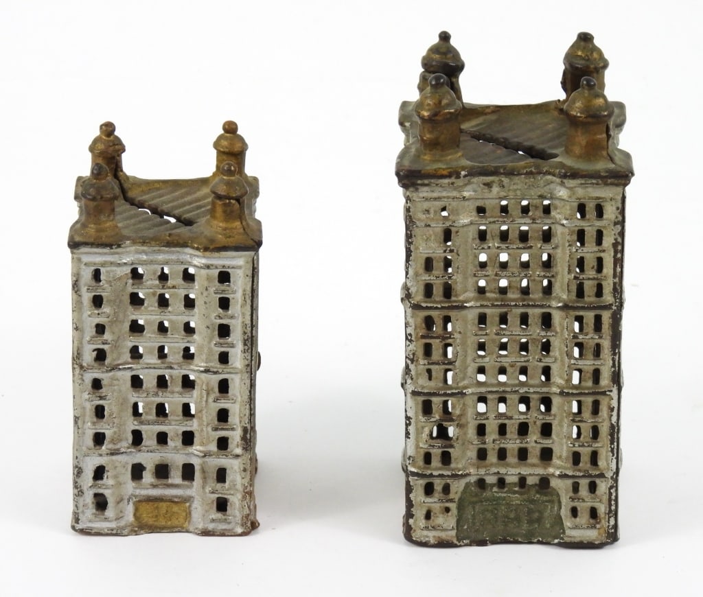 Two Cast Iron Sky Scraper Banks: Likley made by the A.C.Williams Company in Ohio. Both are Sliver and Gold colored paint. Largest measures 5-1/2" high and small one measures 4-1/2" high.