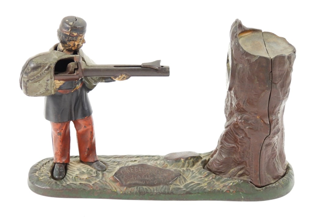 19th-C Creedmoor Mechanical Bank: Cast iron "Bowen's Series" J E Stevens Company made bank that works when the right foot is pressed. Measures 10" long x 6-1/2" high x 3" wide.