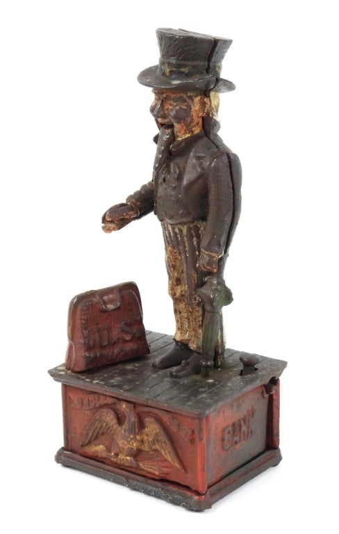 Antique Uncle Sam Mechanical Cast Iron Bank: Appears to be a Shepard Hardware Company bank. Works when operated. Measures 4-3/4" x 3-3/4" x 11-1/4" high. Missing till door cor coins.