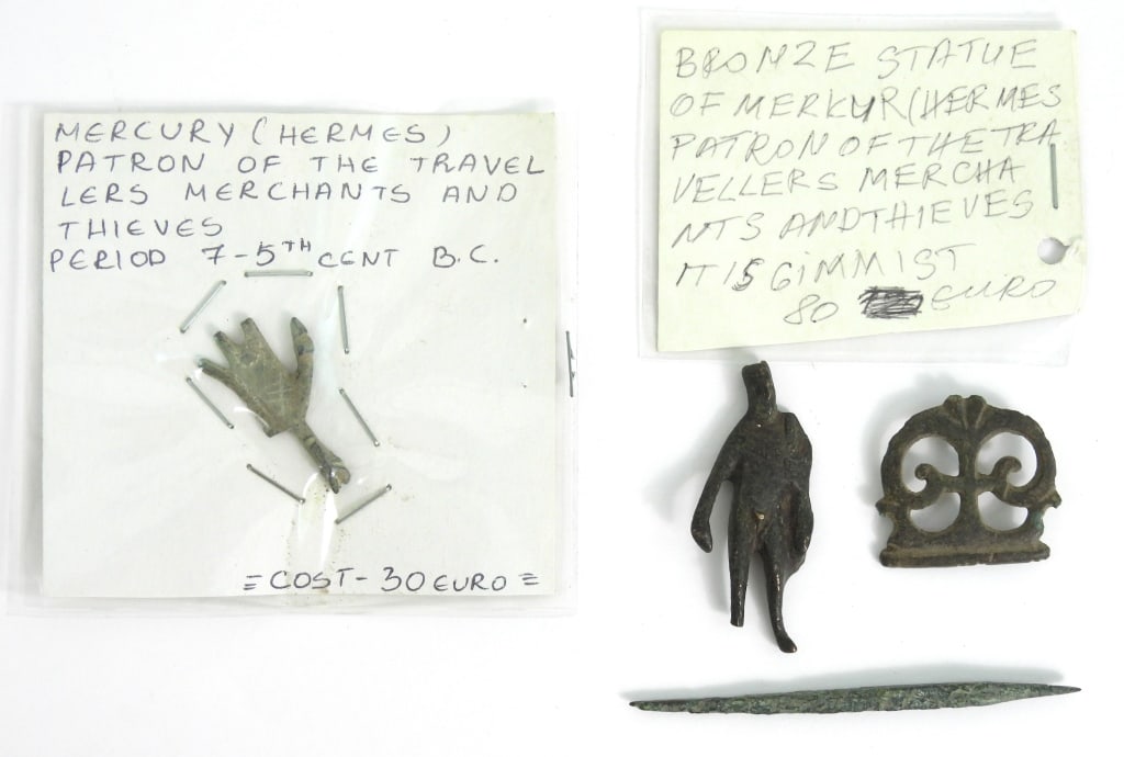 Ancient Roman Era Items: Includes a 1-1/4" x 1-1/4" belt plate. A small 2-1/8" bronze statue relic of Hermes. A cloak pin 3-1/4" long. And a 1-1/2" long relic statue of Mercury Hermes.