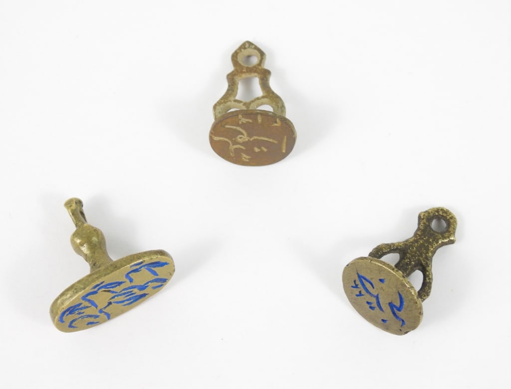 3 Ancient Bronze Seals: Each measure under 1" long and have Arabic witting. Age unknown.