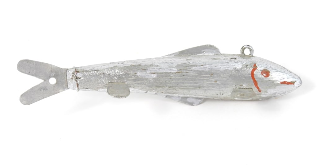 Antique Minnow Silver Color Fish Decoy: Minnow formed spear fishing decoy having metal fins, a weighted wood body with red painted eyes, mouth and gills. Measures 5" long.