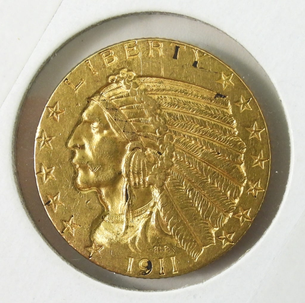1911 U.S. Gold $5 Indian Head Half Eagle: First US incuse struck coin. $5 dollar in good circulated condition wear on edges and headdress with grime in areas.