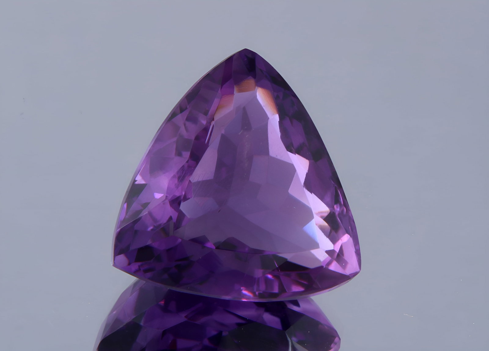 Top Purple Natural Amethyst - 11.94 Cts: Gemstone : Natural AmethystOrigin : BrazilWeight : 11.94 caratsDimensions: 16x15 mm, Shape/Cut : Trillion CutColour: PurpleTransparency: TransparentTreatment: NoneClarity: VS