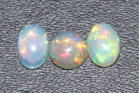 Marvellous " Fire Ethiopian Opal " 1.18 Cts Natural Ethiopian Opal Lot: Gemstone : Natural OpalShape and cut : Oval, Round CabochonWeight : 1.18 CaratsMeasurements : 6x4 mm, 5x5Color : WhiteNumber of Stone : 3Transparency : TranslucentTreatment : NoneOrigin : Ethiopian Cl