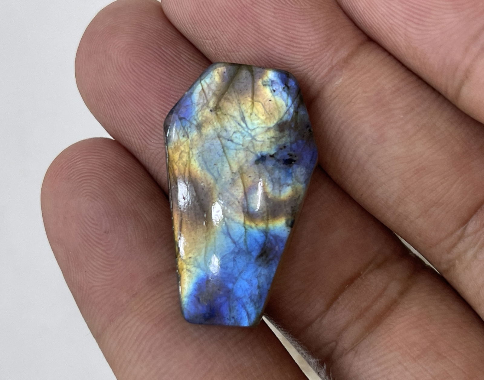 Multicolor 28.59 Cts Natural Labradorite: Gemstone : Natural LabradoriteShape : Coffin CabochonWeight : 28.59 caratsMeasurements : 29x18 mm, Color : BlackTransparency : OpaqueTreatment : NoneOrigin : Madagascar