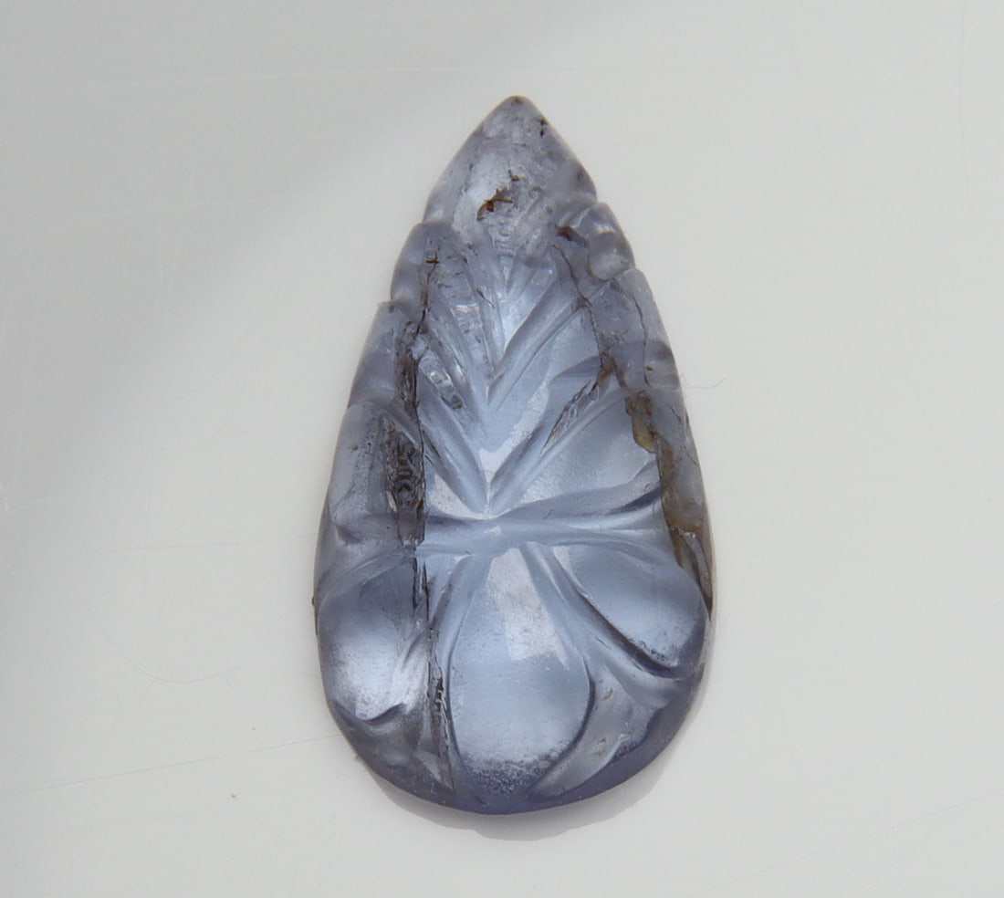Delightful 3.33 Cts Natural AA Blue Tanzanite Carving: Gemstone : Natural Tanzanite CarvingOrigin: Tanzania Weight : 3.33 carats Measurements : 15x8 mm Shape/Cut: Pear Cut Color : Violetish Blueish Blueish Blue Transparency: transparent Treatment: Heated 