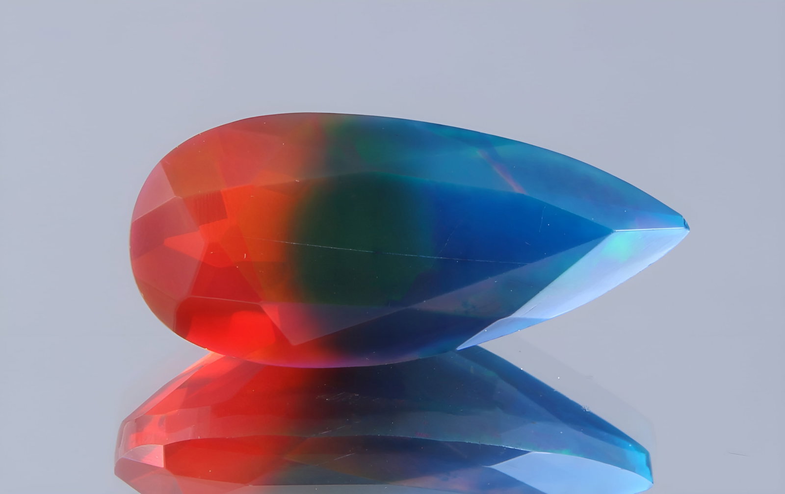 Beautiful 2.10 Cts Natural Bi-Color Ethiopan Opal: Gemstone : Natural Bi Colour Ethiopian Opal Shape / cut : Pear Cut Weight : 2.10 Carats Dimensions : 14.66x6.66x5.72 mm Color : Blue, Pink Transparency : Transparent Treatment : Dye Origin : Ethiopian