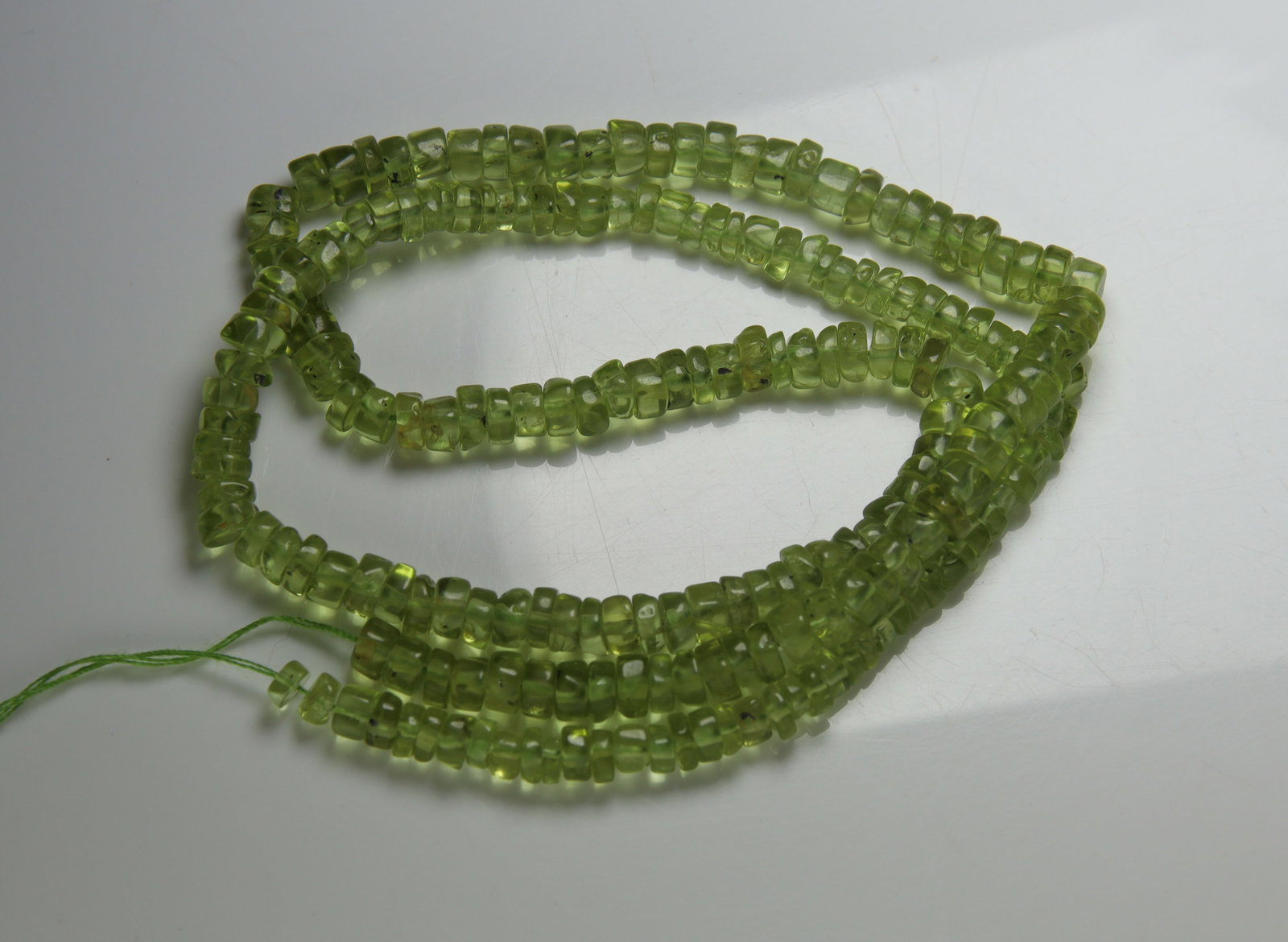 Spectacular " Natural Peridot " 58.72 Cts Natural Peridot: Gemstone : Natural Peridot Weight : 58.72 carat Shape / Cut : Rondelle Beads Dimensions : 4x4 mm Color : Green Origin : India Treatment : No Treatment Transparency : Transparent Shipping-: Flat rate o