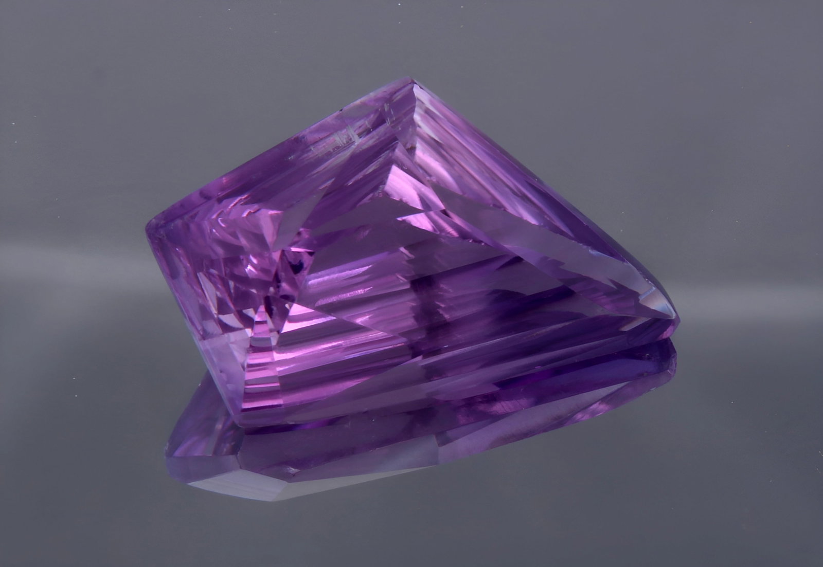 Marvellous 12.11 cts Natural Amethyst: Gemstone : Natural Amethyst Origin : Zambia Weight : 12.11 carats Dimensions: 22x13 mm Shape /Cut : Fancy Cut Colour: Purple Transparency : Transparent Treatment : none Clarity: VVS Shipping-: Flat ra