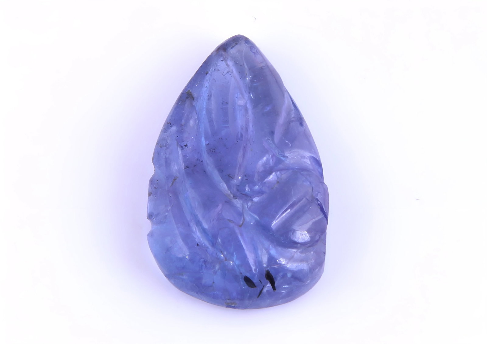 AAA Color Natural Tanzanite Carving - 4.30 Cts: Gemstone : Natural Tanzanite Origin: Tanzania Weight : 4.30 carats Dimensions : 14x9 mm Shape /Cut: Pear Carving Color : Violetish Blueish Blue Transparency : transparent Treatment : Tradtional Heat S