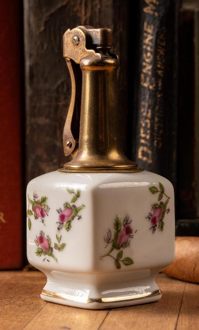 Antique Japanese Porcelain Hand Painted Lighter: Antique hand-painted porcelain Japanese lighter that features a closed cherry blossom motif and a long, brass stem. This lighter may require flint or other mechanical parts. All lighters are sold as-i