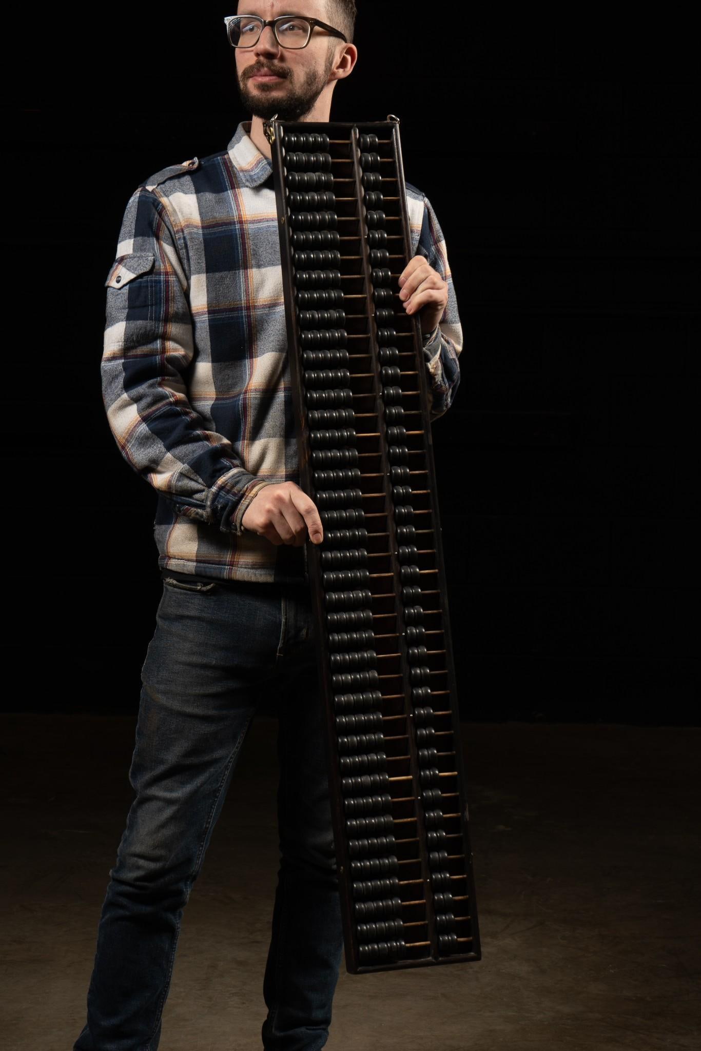 Antique Wooden Abacus: Large wooden abacus with chain for mounting. Chain exhibits rust, but the piece as a whole appears to be in good condition. 46" W x 7" H