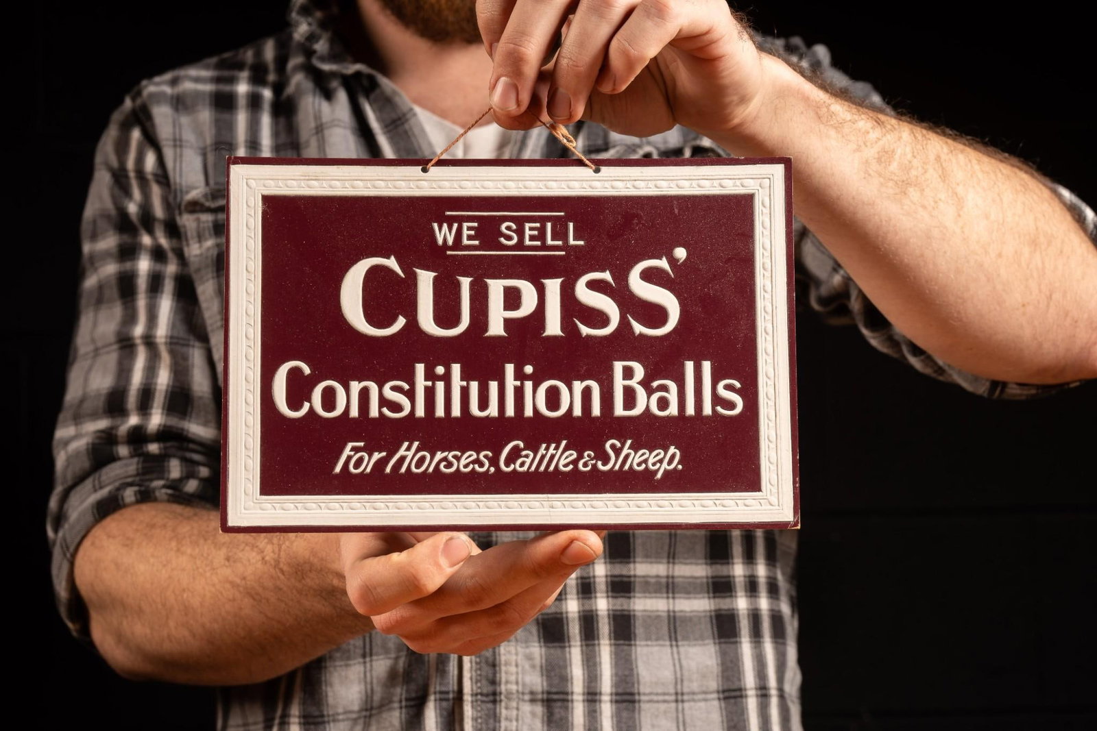 Antique Cupiss Constitution Balls Sign: c. 1920s embossed cardboard advertising sign for Cupiss' Constitution Balls (a purgative and diuretic ball for horses) invented by former New York mailman Francis Cupiss, M.R.C.V.S. The ingredient
