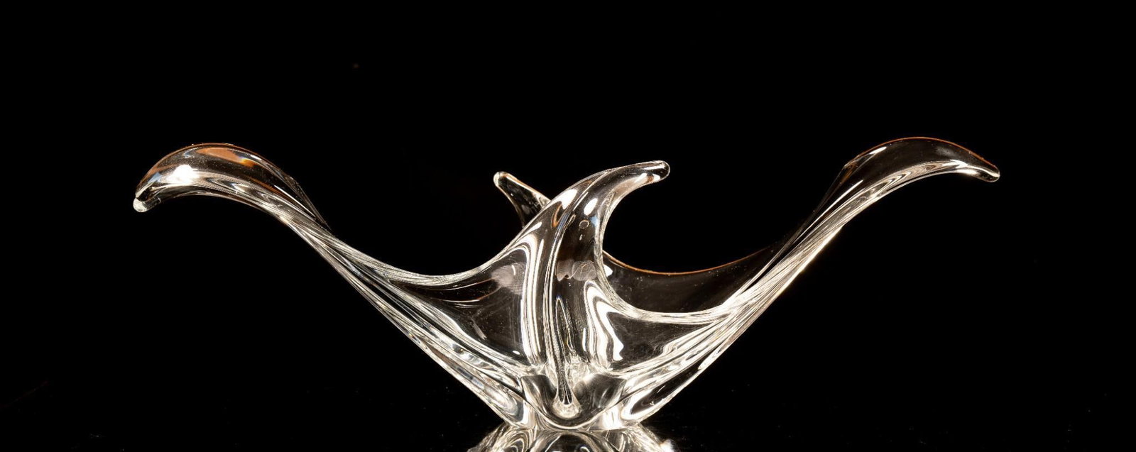 Large Abstract Manta Ray Blown Glass Bowl: Figural blown glass bowl whose elegant curves and ridges are reminiscent of a manta ray. Appears to be free from cracks and chips, but exhibits minor scratches. 21.5" W x 12" D x 7" H