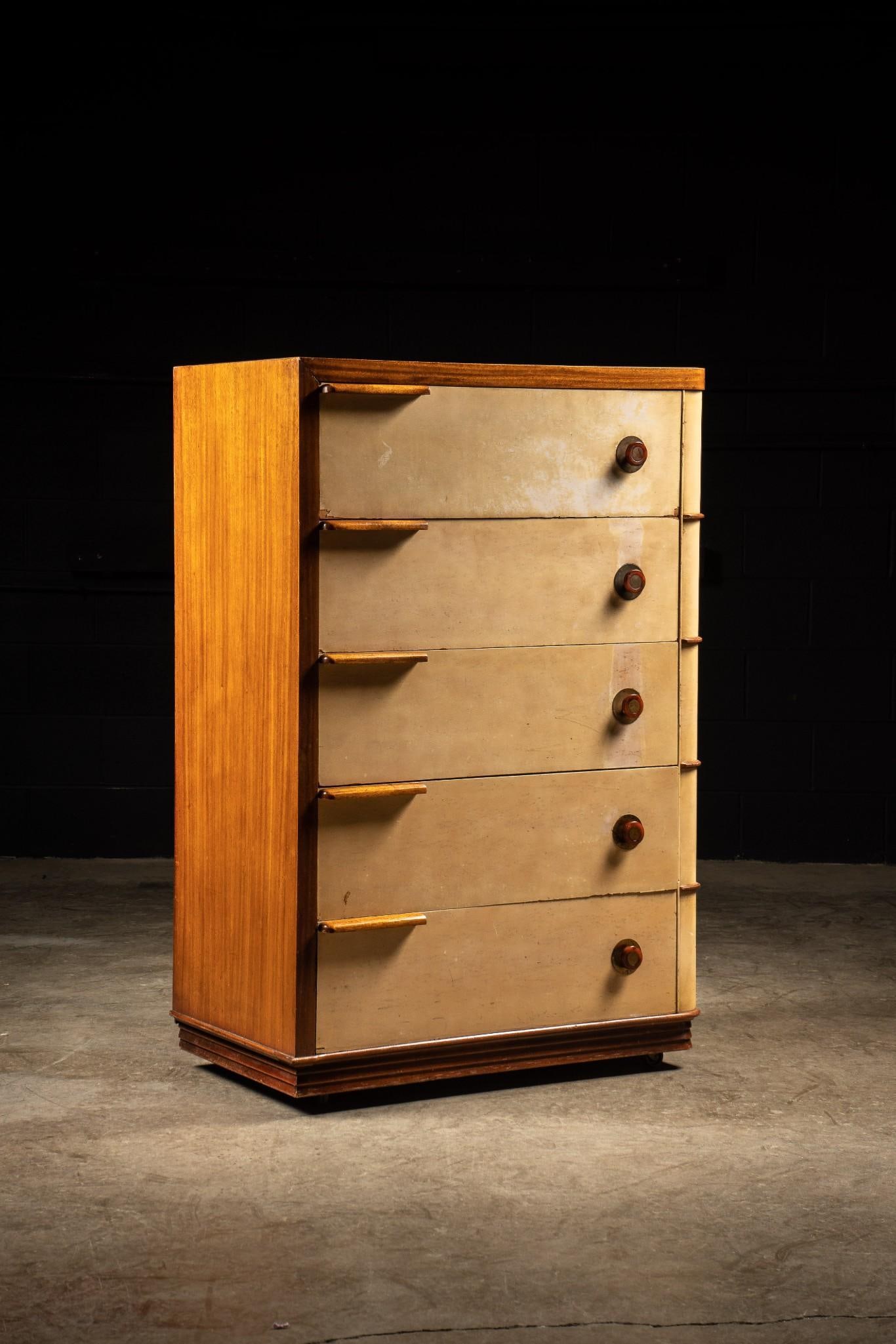 c. 1930 Gilbert Rhode/Donald Deskey Dresser: Vintage Streamline Moderne dresser of oak construction. Features five drawers of uniform size with metal and bakelite pulls. Please note that the dresser has scratches and there is paint wear across