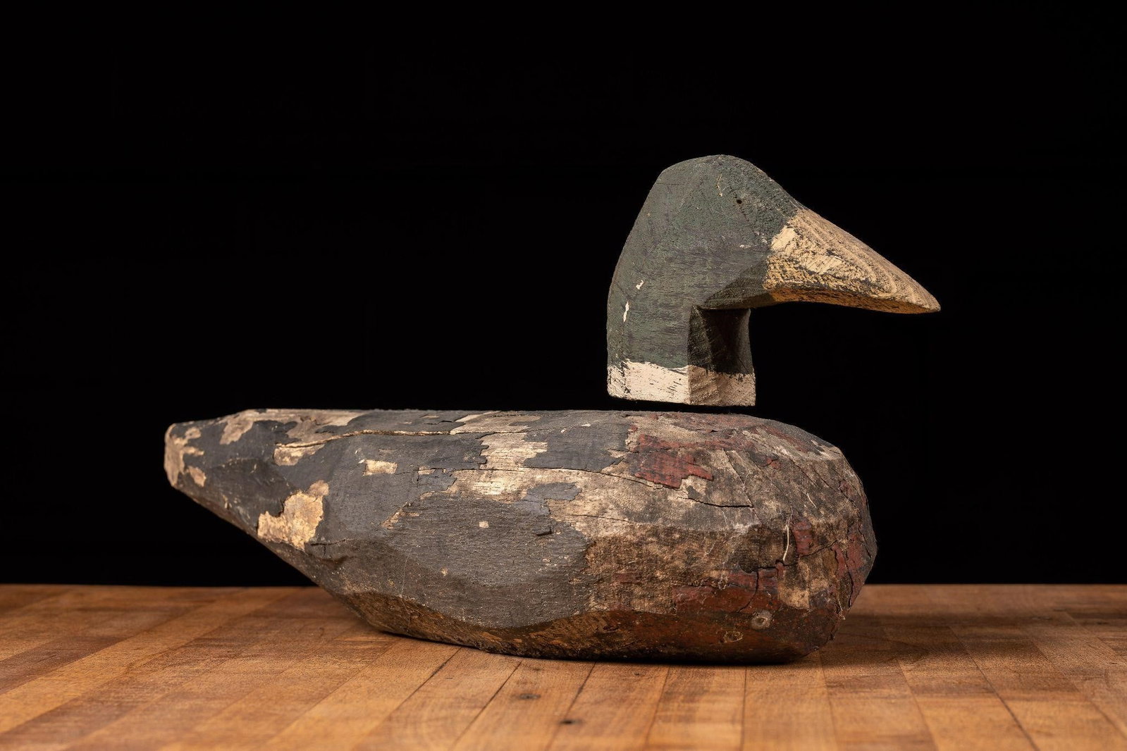 Early Painted Folk Art Wooden Duck Decoy: Item SKU: 105762 Antique Duck Decoy with dimensions measuring 14.5" L x 5.5" D x 7.5" H. Little information is available about this particular duck decoy. This decoy is presumed to be hand carved with