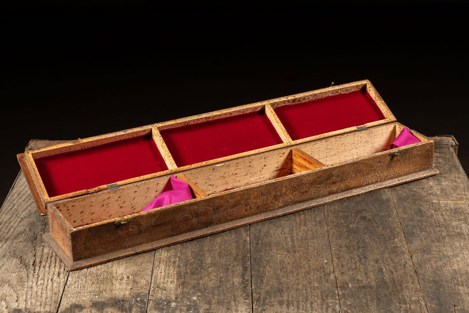Early 20th Century Carved Wooden Presentation Box: NOTE: For an accurate in-house shipping quote on this lot, please reach out to us at rockauctiongallery@gmail.com. Item SKU: C-13411 This elongated wooden box features a hinged lid and hand-tooled flo