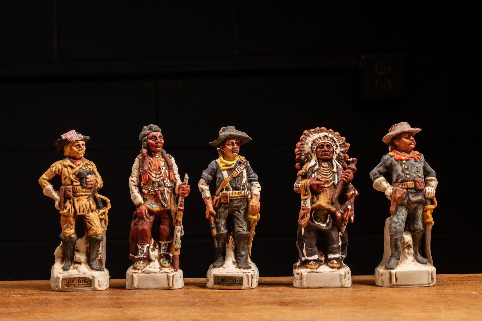 Vtg Lewis & Clark Bourbon Porcelain Decanter Set: NOTE: For an accurate in-house shipping quote on this lot, please reach out to us at rockauctiongallery@gmail.com. Item SKU: C-8643 c. 1970s; designed by Gary Schildt for Alpha Industries - Helena, MO