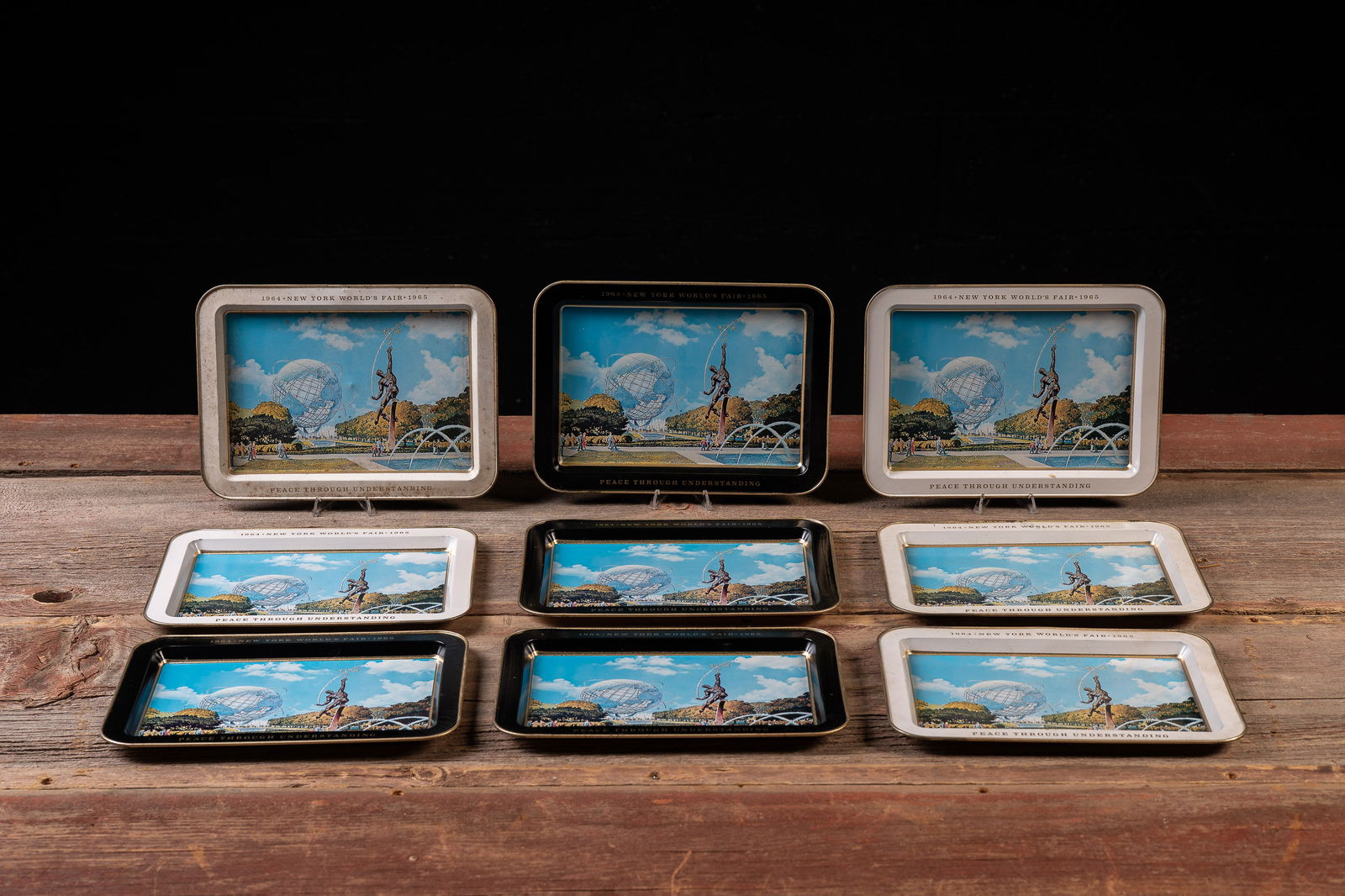 Lot of 9 1964-1965 New York World's Fair Trays: **NOTE: Any shipping quotes provided on this screen are provided by Live Auctioneers. For an in-house shipping quote on this lot, please reach out to us at rockauctiongallery@gmail.com.** 