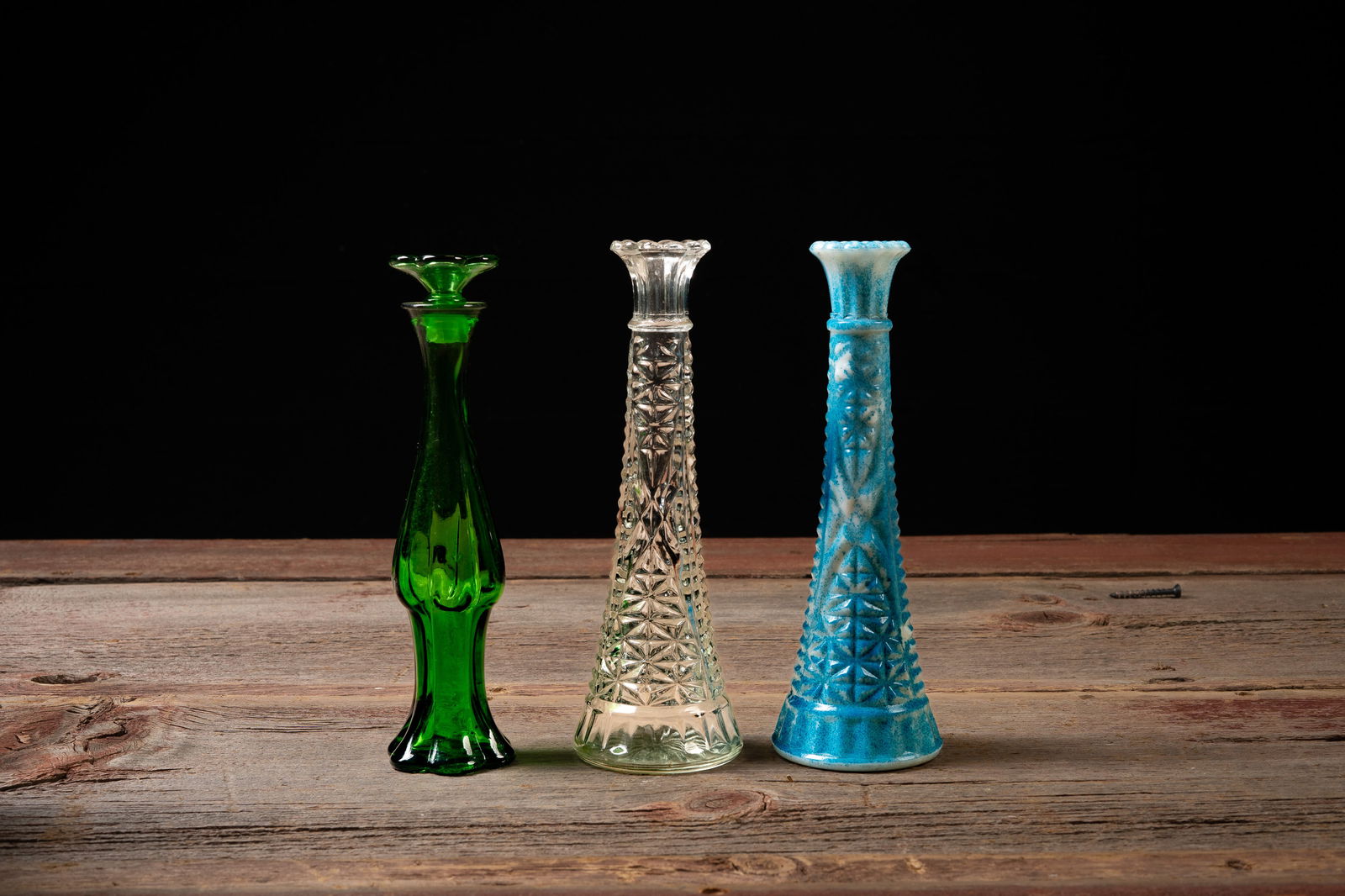 Midcentury Art Glass Bud Vase Trio: Asst. Colors: **NOTE: Any shipping quotes provided on this screen are provided by Live Auctioneers. For an in-house shipping quote on this lot, please reach out to us at rockauctiongallery@gmail.com.** 