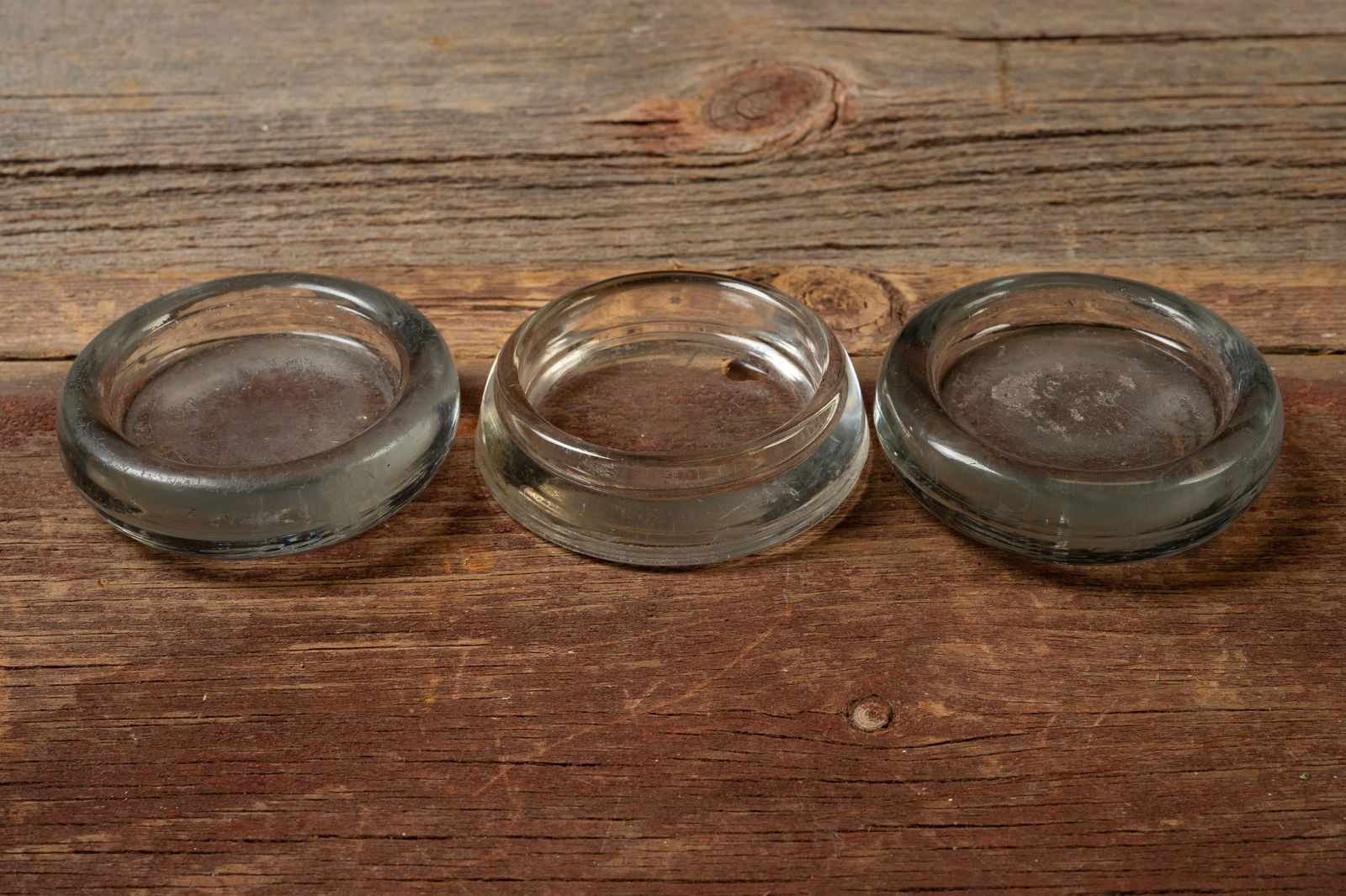 Three Heavy Clear Glass Ashtrays â€“ Industrial Form: **NOTE: Any shipping quotes provided on this screen are provided by Live Auctioneers. For an in-house shipping quote on this lot, please reach out to us at rockauctiongallery@gmail.com.** 