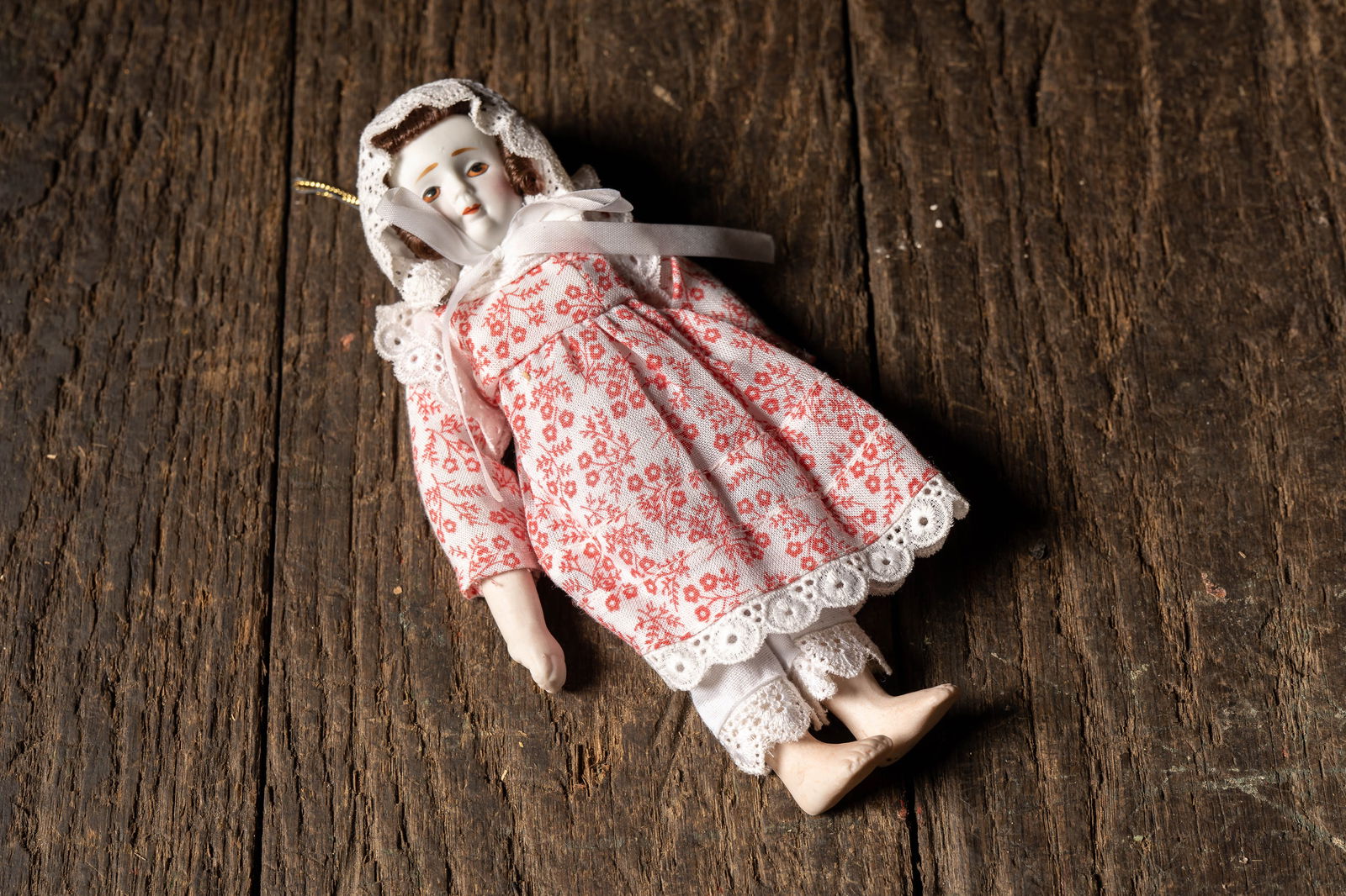 Porcelain Ornament Doll in Floral Prairie Dress: **NOTE: Any shipping quotes provided on this screen are provided by Live Auctioneers. For an in-house shipping quote on this lot, please reach out to us at rockauctiongallery@gmail.com.** 