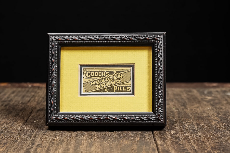 Gooch’s Mexican Brand Pills Label in Ornate Frame: **NOTE: Any shipping quotes provided on this screen are provided by Live Auctioneers. For an in-house shipping quote on this lot, please reach out to us at rockauctiongallery@gmail.com.** 