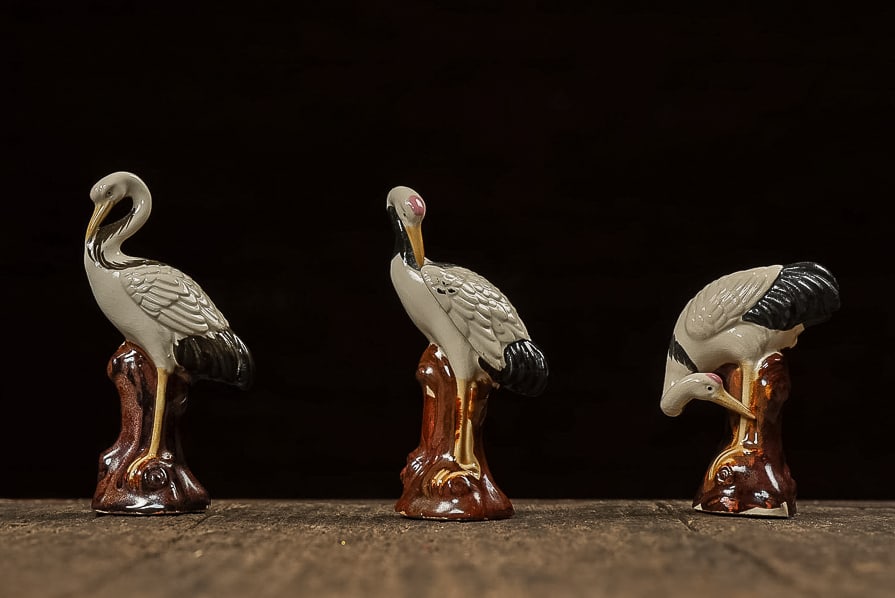 Mid-C. Chinoiserie Porcelain Crane Figurines: **NOTE: Any shipping quotes provided on this screen are provided by Live Auctioneers. For an in-house shipping quote on this lot, please reach out to us at rockauctiongallery@gmail.com.** C-14033 This