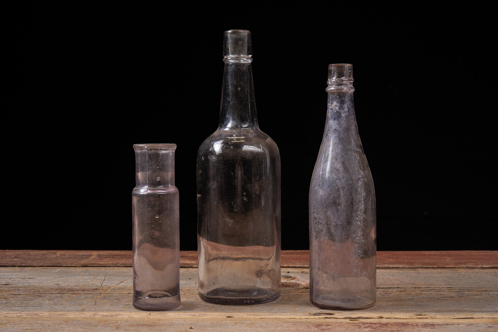 Antique Purple-Hued Glass Bottles: **NOTE: Any shipping quotes provided on this screen or on your Live Auctioneers invoice are provided by Live Auctioneers. In-house shipping is available on all lots. For in-house shipping quotes, plea