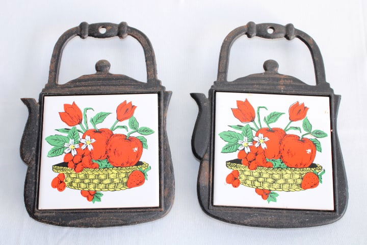 Pair of Vintage Cast Iron and Tile Trivets: kettle form - apple tile - wall decor - marked "San Ho trademark" Taiwan on the back - 1970's - tile: 4 3/8" x 4 1/4" - tea kettle: 8" tall