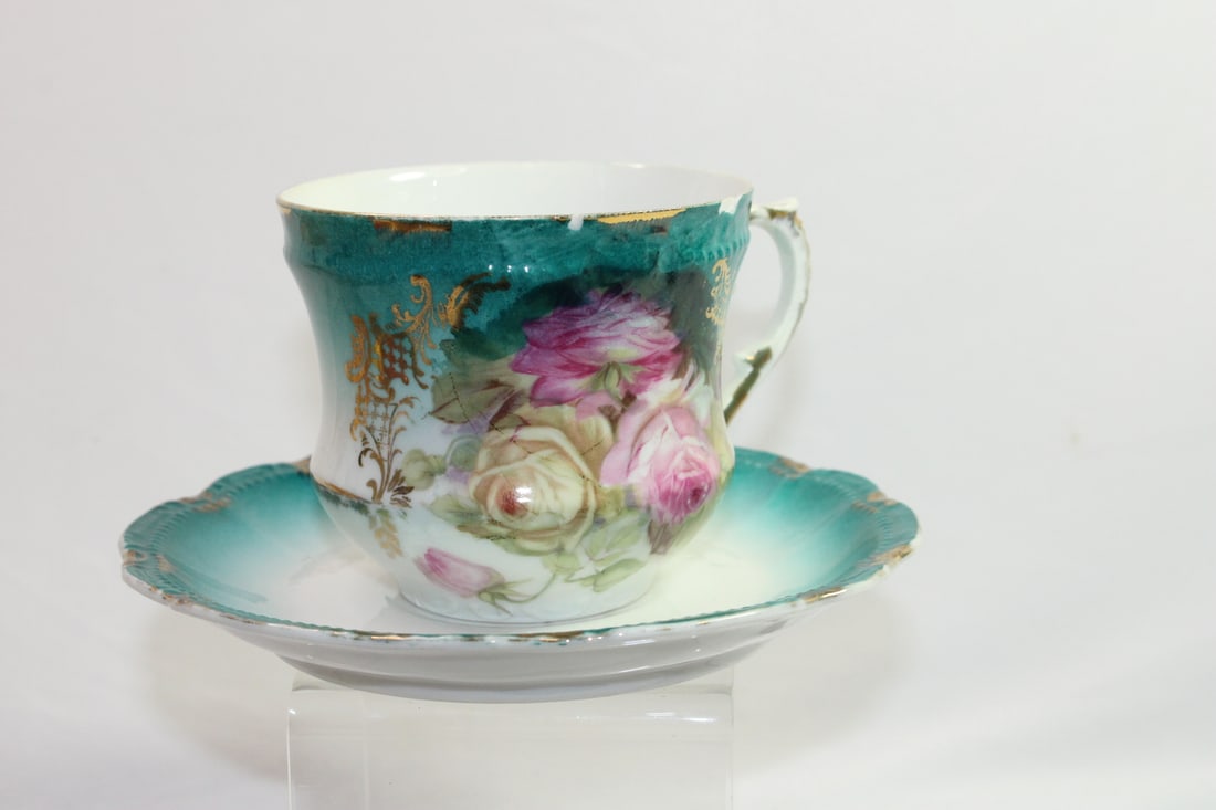 Bavarian Tea Cup and Saucer: marked as shown - please note the fleabites and chips on the cup as shown - saucer has a hairline on the glaze, not showing through - saucer" 5 3/4" in diameter - cup" 3" tall