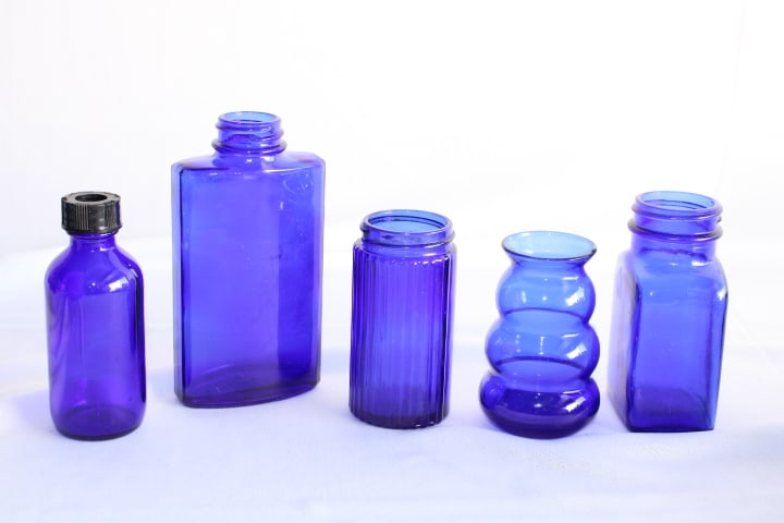 Lot of 5 Various Vintage Cobalt Blue Glass Bottles: two of them marked on the bottom: Bourjois and T-S - tallest (Bourjois): 4 3/4" tall
