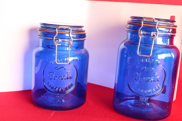 Set of Two Blue Glass Jars: Quality Fresh Glassware, 1941 - from Home Essentials and Beyond - smaller is 6 1/2" tall - larger: 7 1/4" tall