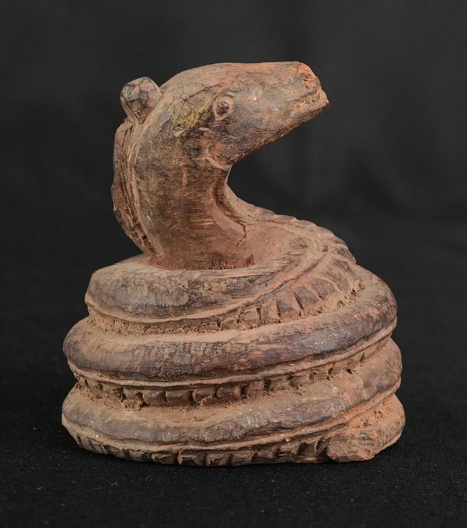 Ancient Egyptian Wood Coiled Snake Statuette: 3" by 2 3/4" by 2 1/2". Roman Period, Circa 2nd-3rd Century A.D. Provenance: Iris Cornelia Love Collection (1933-2020), New York, primarily formed in the 1950s-1970s. Iris Cornelia Love (1933?2020) wa