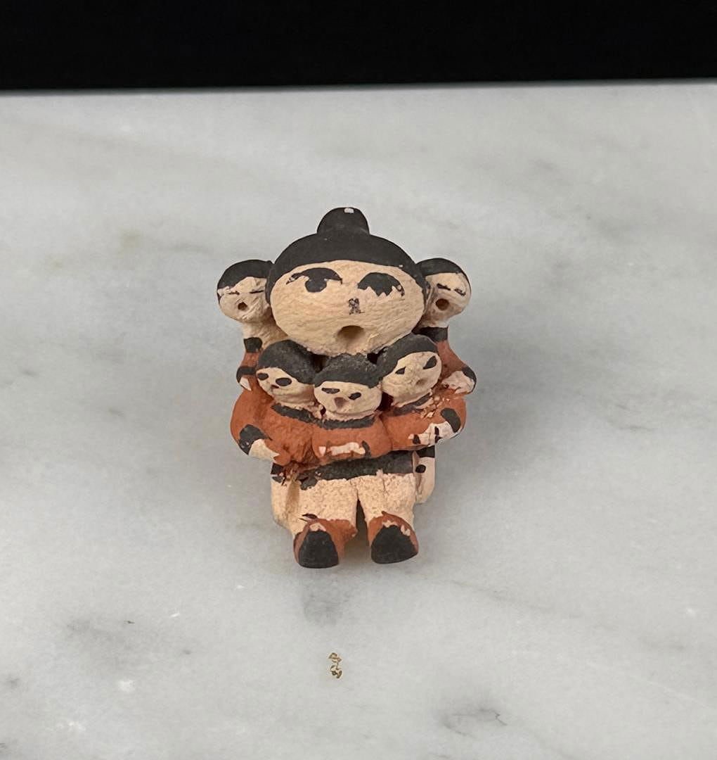 Judy Shields Acoma Pueblo Miniature Storyteller: 1/2" by 1/2" by 3/8".