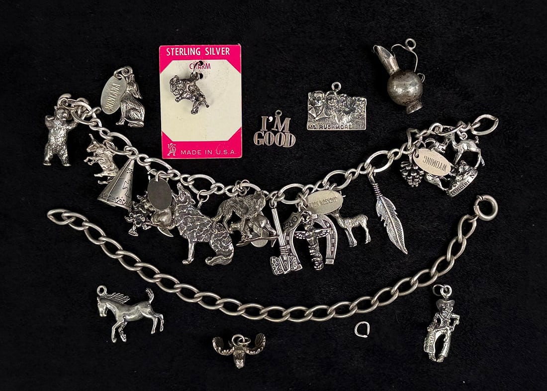 Collection of Sterling Silver Bracelet Charms: 83.94 grams.
