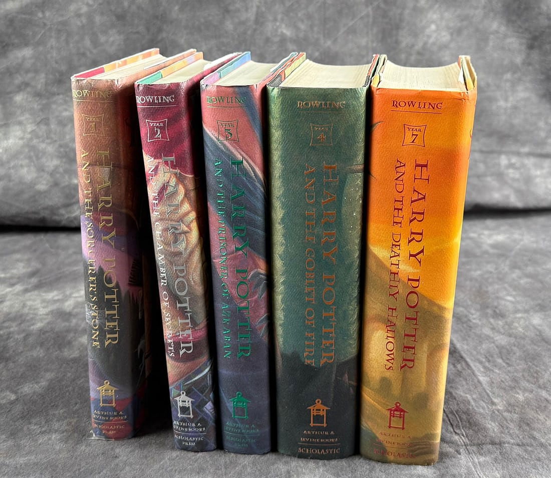 Group Of Harry Potter Books: Five total. The Sorcerer's Stone, The Chamber Of Secrets, The Prisoner of Azkaban, The Goblet of Fire and The Deathly Hallows.