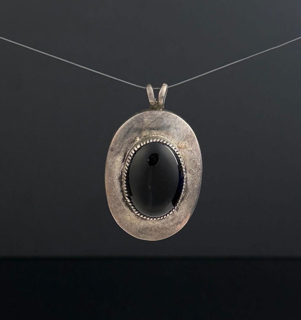 Navajo Sterling Silver Onyx Pendant: 30.95 grams. 2 3/8" long.
