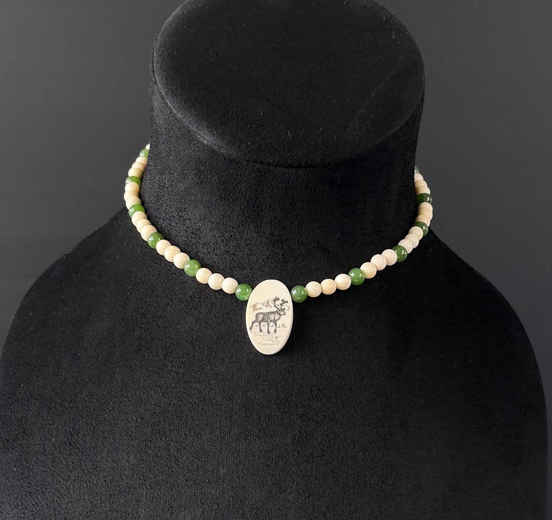Alaskan Inuit Eskimo Walrus Ivory Necklace: Scrimshaw Ivory and Green Jade. This item cannot be shipped to Oregon, California, Hawaii, New York, New Jersey, Internationally, or any other state that prohibits. Measures 8" long as displayed.
