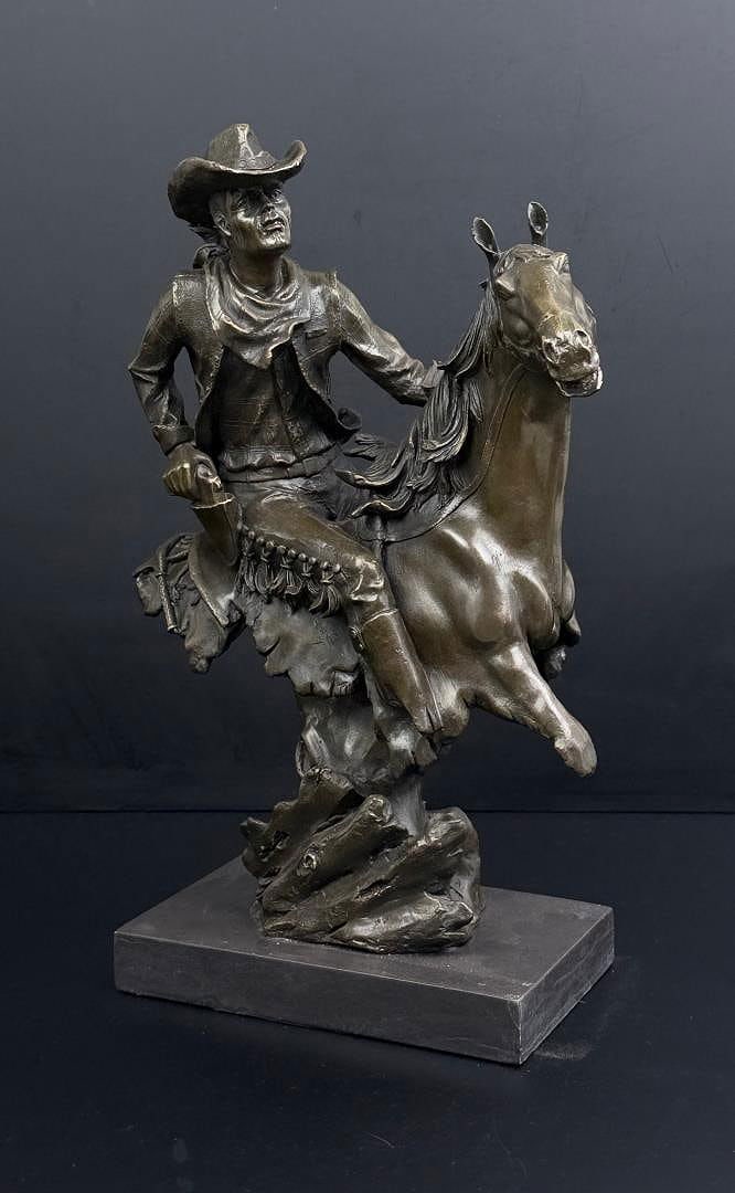 Armed Cowboy on Horseback Bronze: 15 1/4" by 10 3/4" by 5 3/4".