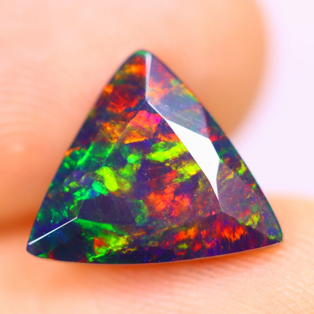 1.70Ct Welo Black Opal Polished - Ethiopian Opal - Triangle Faceted: Ksmith Jewels Global Welcome to our auction house, today auction brought to you by Ksmith Jewels Global based in Penang, Malaysia specialize in all kinds of opal and color gemstone both in manufacturi