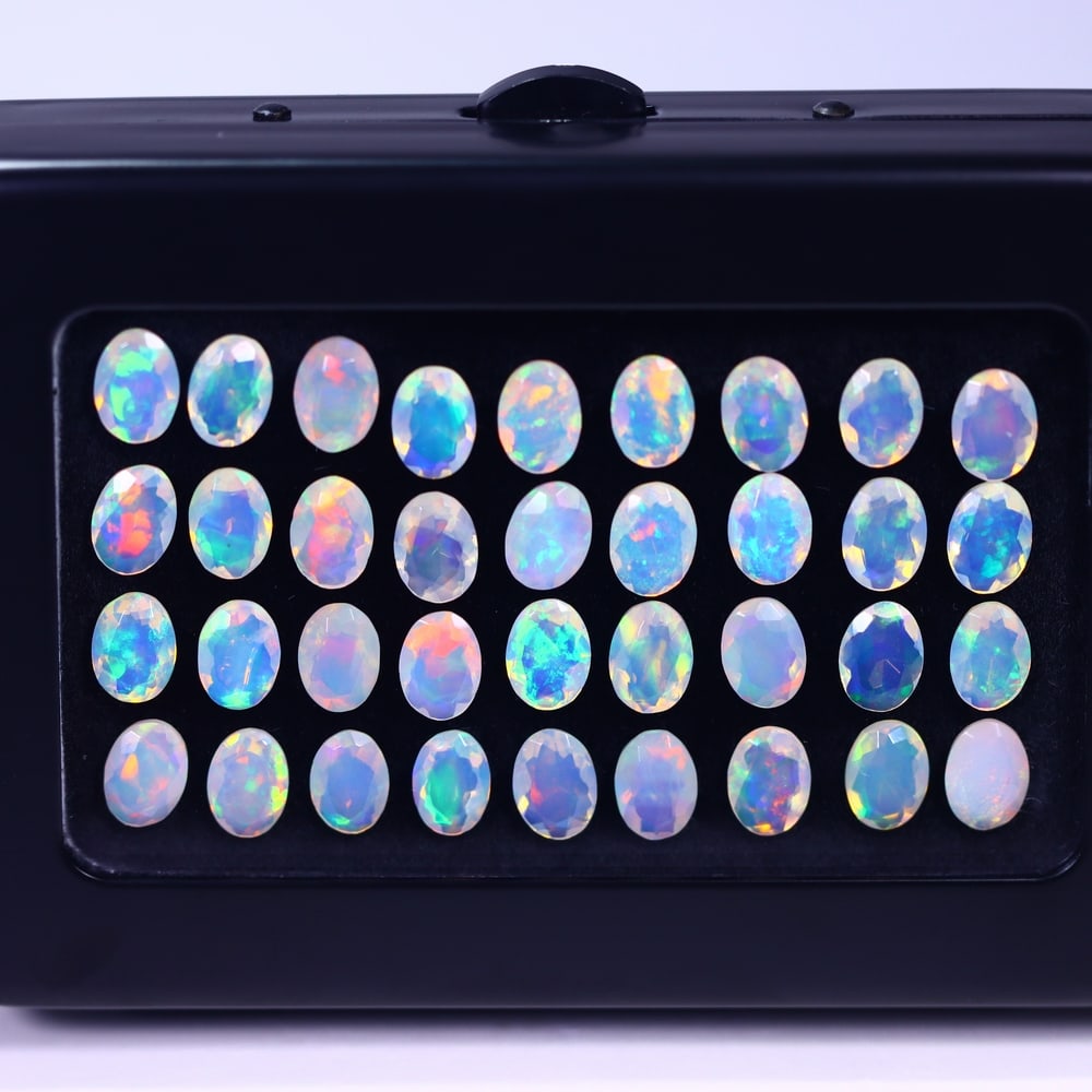 *17.34Ct Calibrated 7x5mm Faceted Welo Opal Set - Ethiopian Opal , 152E: Ksmith Heritage Auctioneers Subject: Natural Ethiopian Welo Opal Origin: Ethiopia Carat Weight: 17.34Ct Treatment: Natural Untreated Type: Faceted, Polished