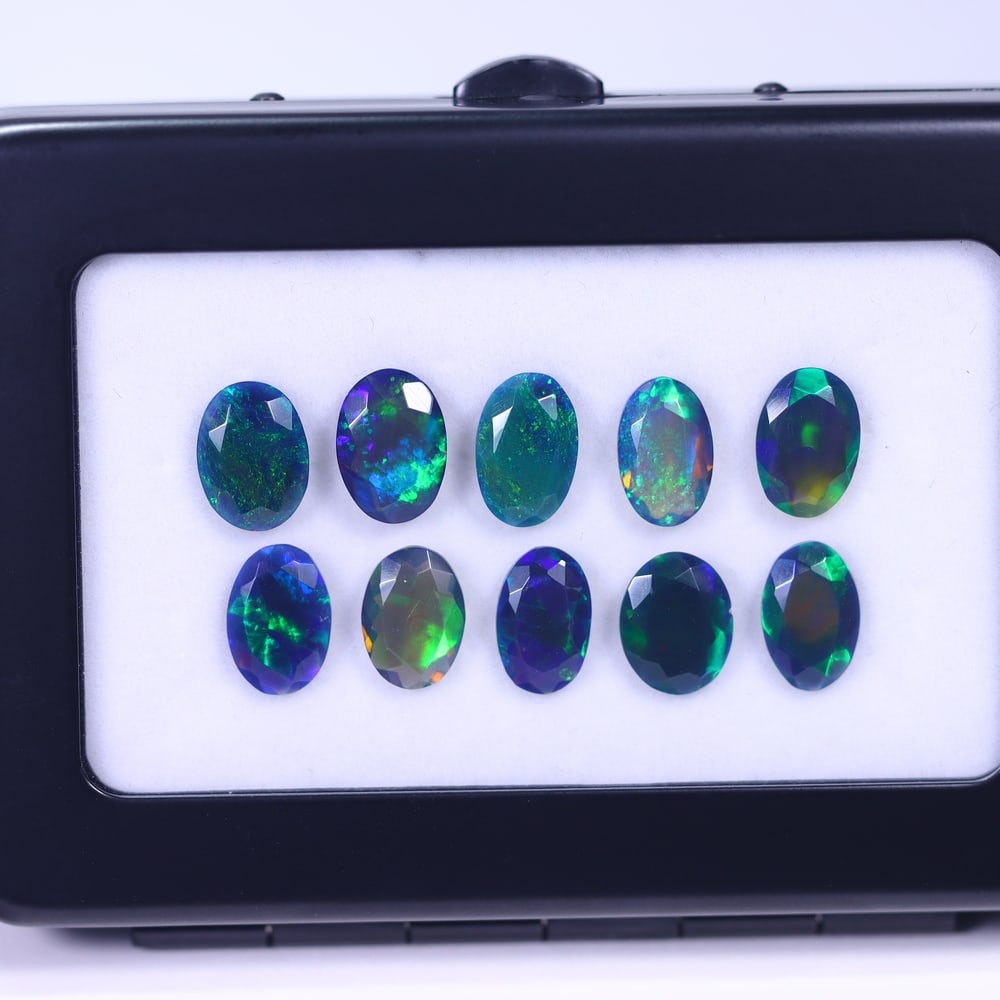 *11.68Ct 10pcs Faceted Smoked Welo Opal Set - Ethiopian Opal , 973E: Ksmith Heritage Auctioneers Subject: Natural Ethiopian Black Welo Opal Origin: Ethiopia Carat Weight: 11.68Ct Dimension: 10x7x3 mm Treatment: Heated Type: Faceted, Polishe