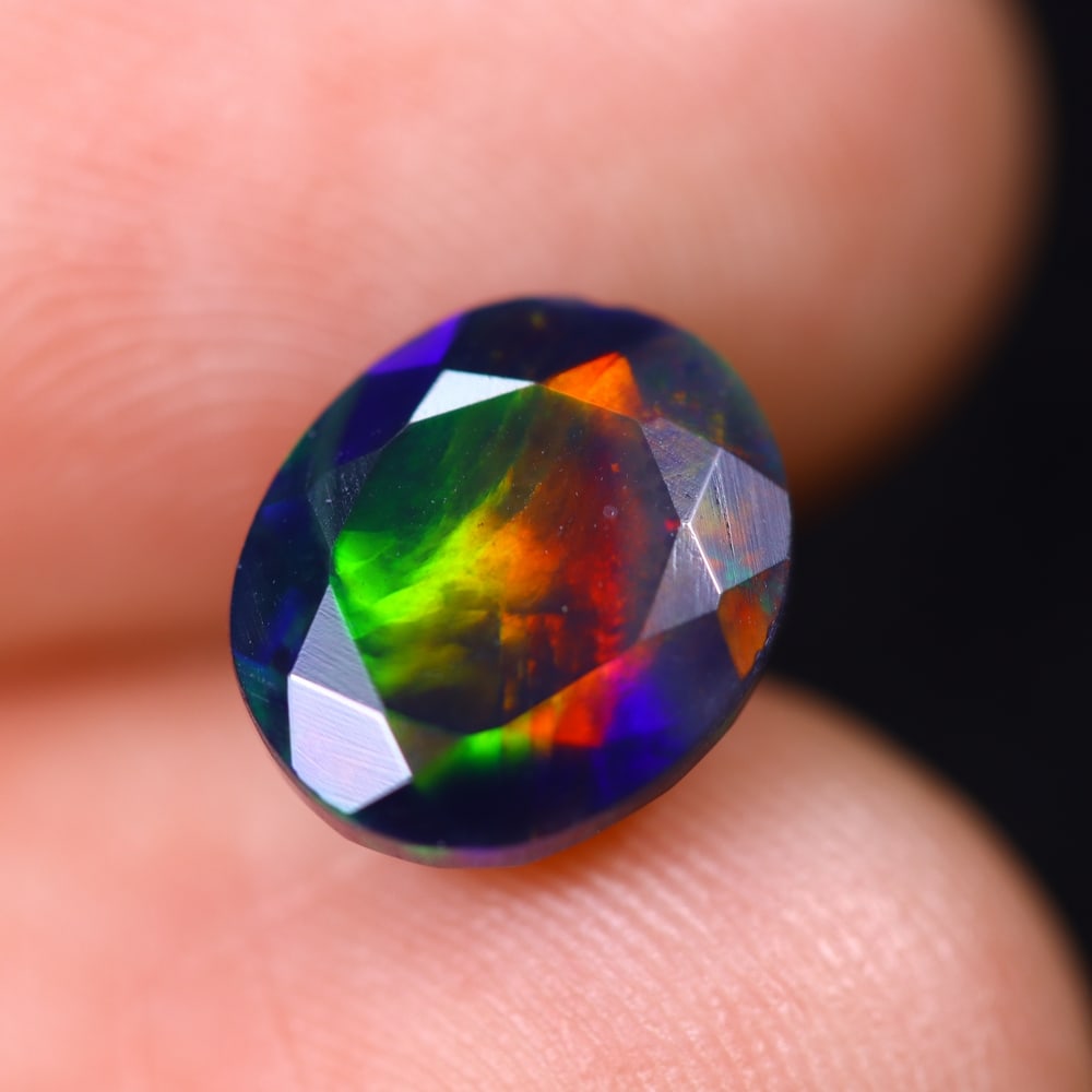 2.06Ct Welo Black Opal Faceted Polished - Ethiopian Opal , 252E: Ksmith Heritage Auctioneers Subject: Natural Ethiopian Welo Black Opal Origin: Ethiopia Carat Weight: 2.06Ct Dimension: 9.6x8.1x5.9 mm Treatment: Smoked Type: Faceted, Pol