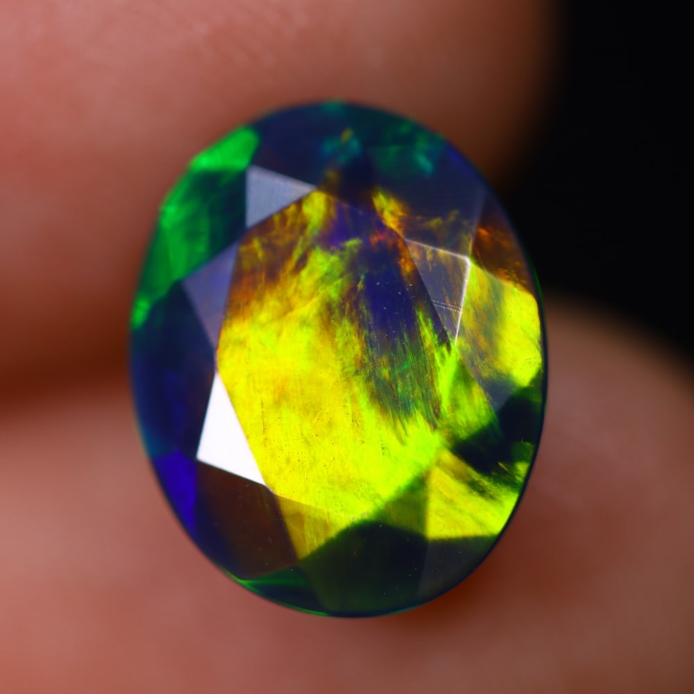 2.38Ct Welo Black Opal - Ethiopian Opal - Faceted Polished , 1100E: Ksmith Heritage Auctioneers Subject: Natural Ethiopian Welo Black Opal Origin: Ethiopia Carat Weight: 2.38Ct Dimension: 12.2x9.9x4.8 mm Treatment: Smoked Type: Faceted, Po